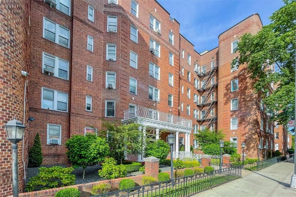 601 79th Street, Unit D11 Brooklyn, NY 11209 - Photo 1 of 19 a view of a building in front of a big yard plants and large trees