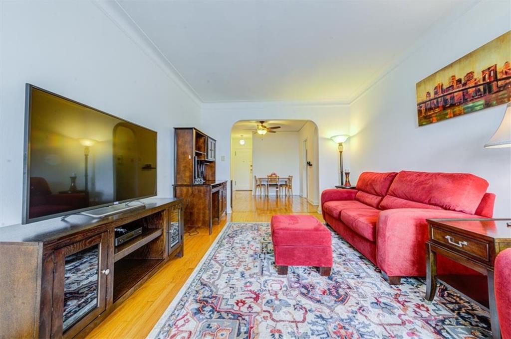 601 79th Street, Unit D11 Brooklyn, NY 11209 - Photo 12 of 19 a living room with furniture and a flat screen tv