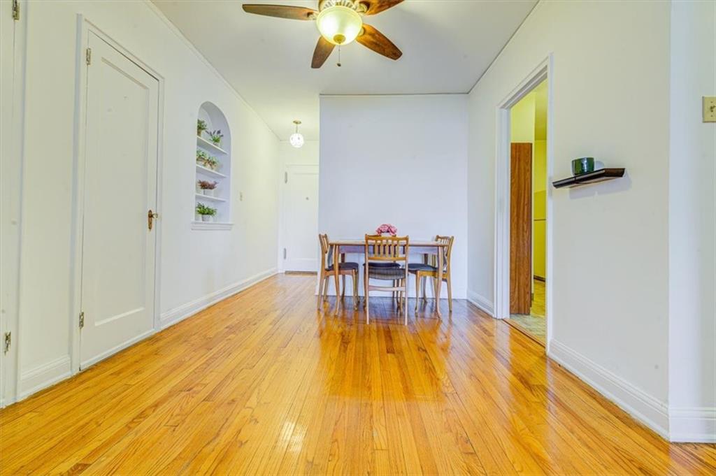 601 79th Street, Unit D11 Brooklyn, NY 11209 - Photo 13 of 19 a view of a dining room with furniture and wooden floor