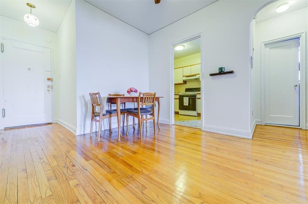 601 79th Street, Unit D11 Brooklyn, NY 11209 - Photo 15 of 19 a view of a dining room with furniture and wooden floor