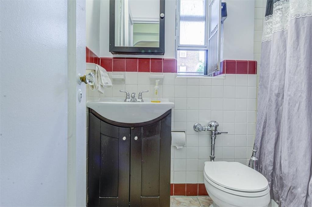 601 79th Street, Unit D11 Brooklyn, NY 11209 - Photo 16 of 19 a bathroom with a sink and a toilet