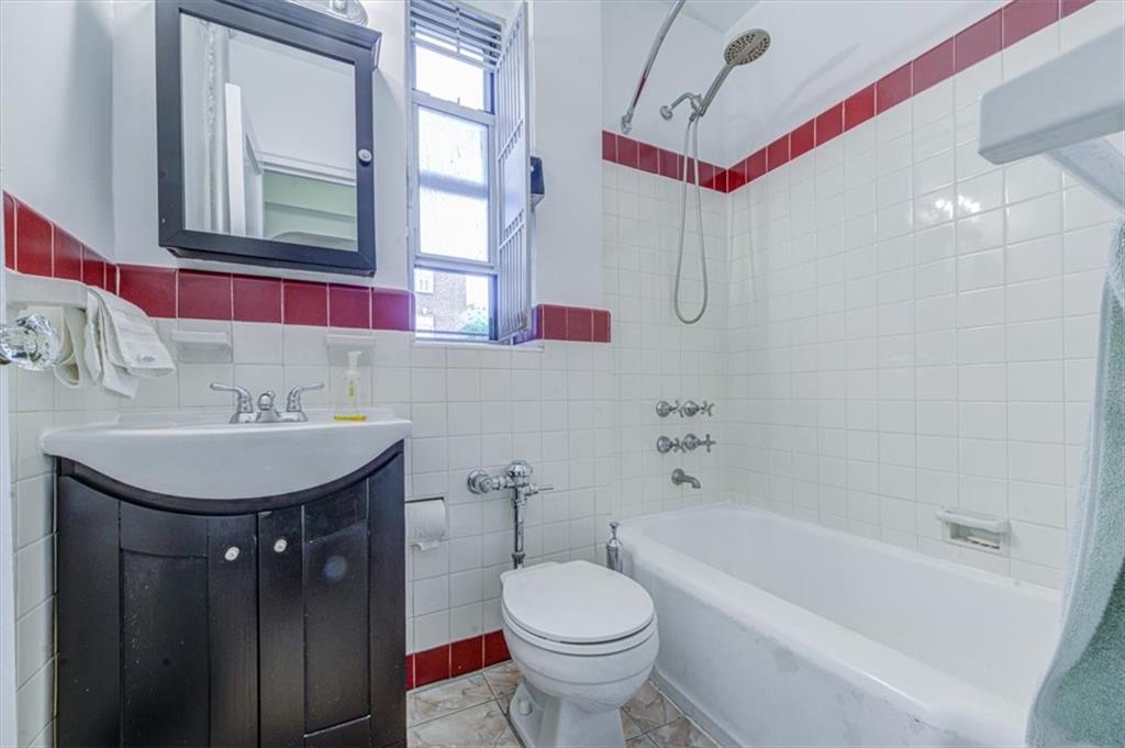 601 79th Street, Unit D11 Brooklyn, NY 11209 - Photo 17 of 19 a bathroom with a sink toilet and shower