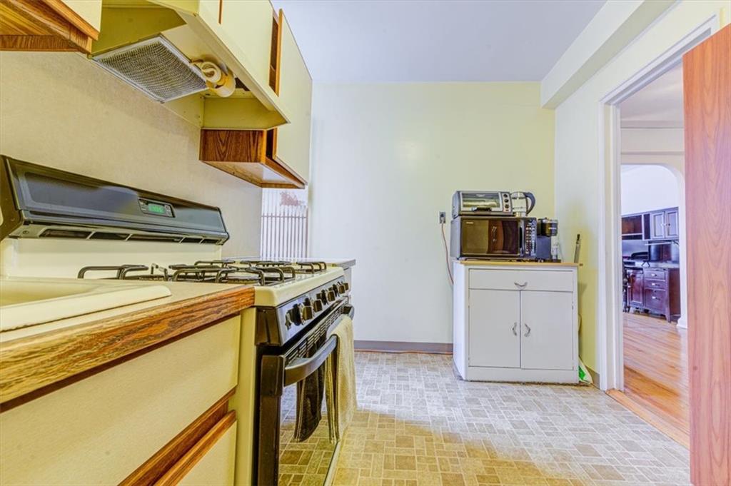 601 79th Street, Unit D11 Brooklyn, NY 11209 - Photo 7 of 19 a kitchen with a stove and a microwave