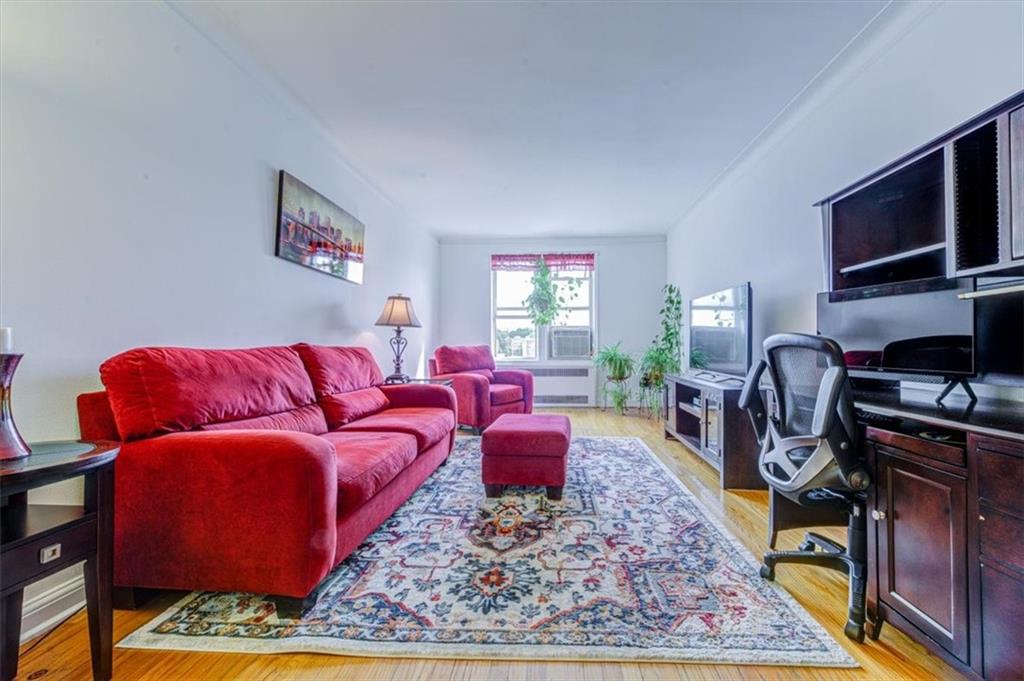 601 79th Street, Unit D11 Brooklyn, NY 11209 - Photo 8 of 19 a living room with furniture a rug and a flat screen tv