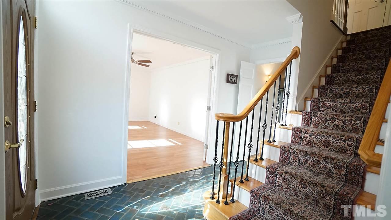 1809 Pony Run Road Raleigh, NC 27615 - Photo 5 of 30 a view of a hallway with wooden floor and entryway