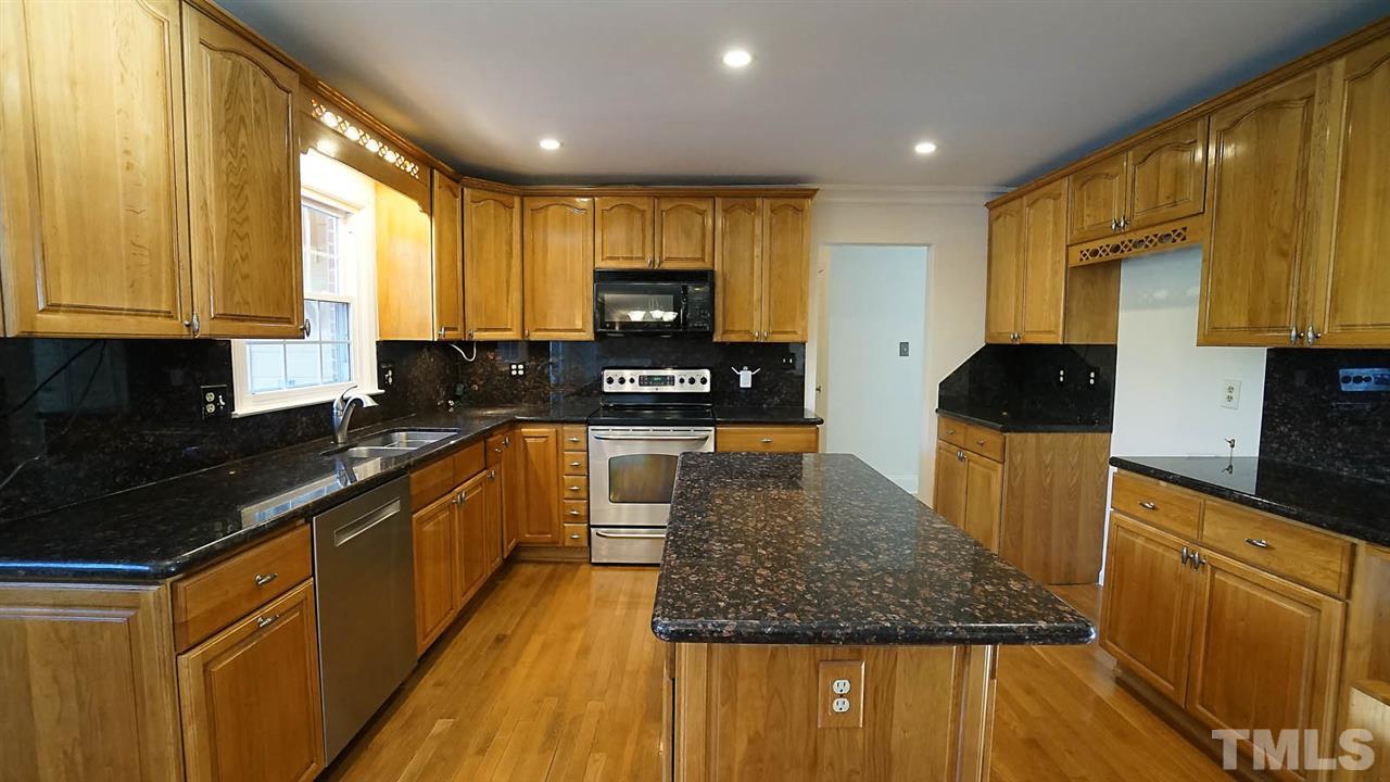 1809 Pony Run Road Raleigh, NC 27615 - Photo 6 of 30 a kitchen with stainless steel appliances granite countertop a sink a stove counter space and a window