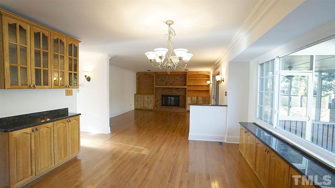 1809 Pony Run Road Raleigh, NC 27615 - Photo 7 of 30 a view of a room with wooden floor and chandelier