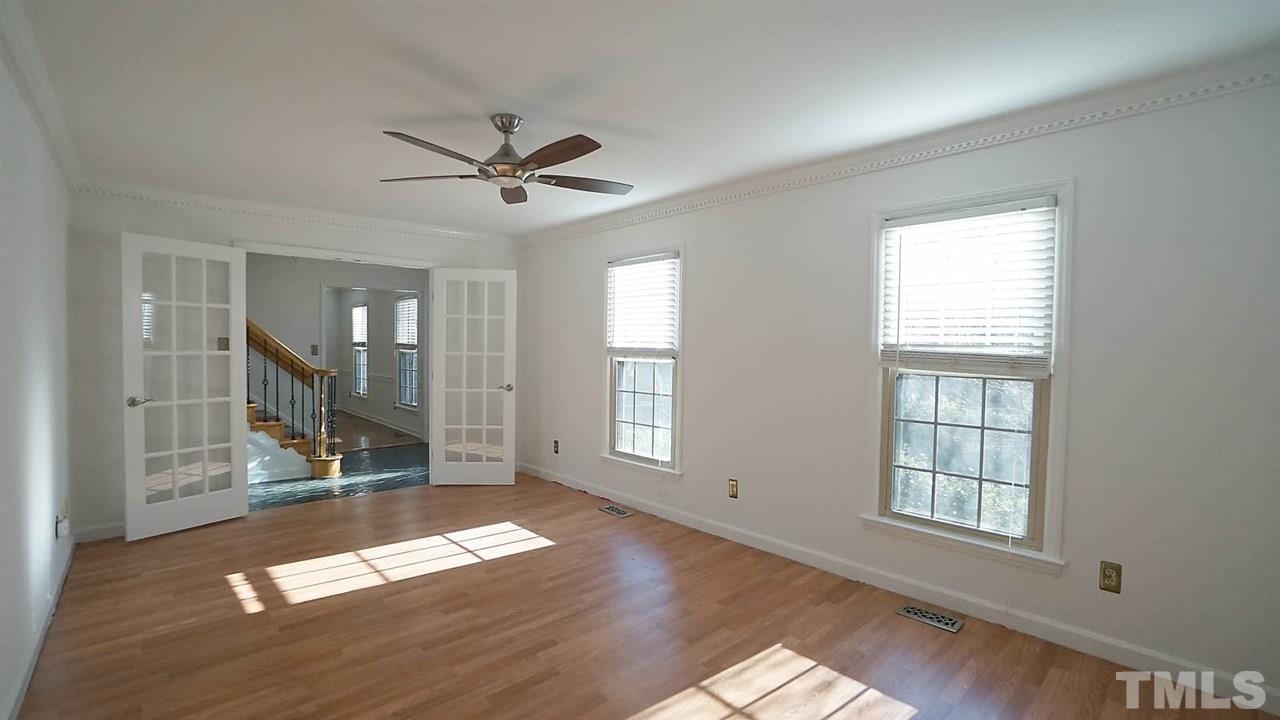 1809 Pony Run Road Raleigh, NC 27615 - Photo 10 of 30 a view of empty room with wooden floor and fan