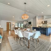 a dining room filled with furniture and wooden floor