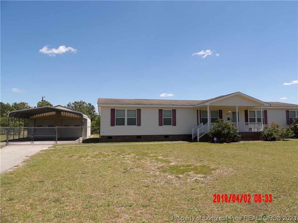 7349 Roslin Farm Road Hope Mills, NC 28348 - Photo 1 of 23 a front view of house with yard and car parked