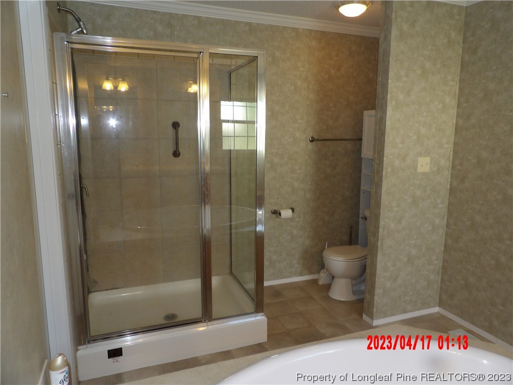7349 Roslin Farm Road Hope Mills, NC 28348 - Photo 17 of 23 a bathroom with a shower a toilet and a sink