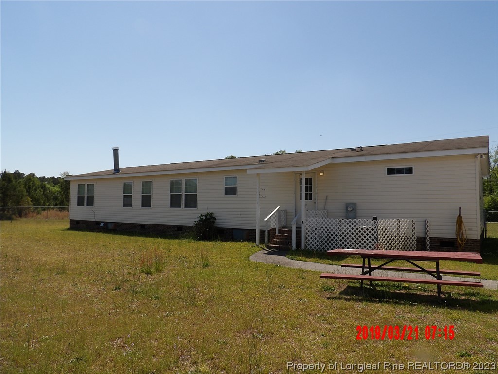 7349 Roslin Farm Road Hope Mills, NC 28348 - Photo 19 of 23 a backyard of a house with garden and outdoor seating