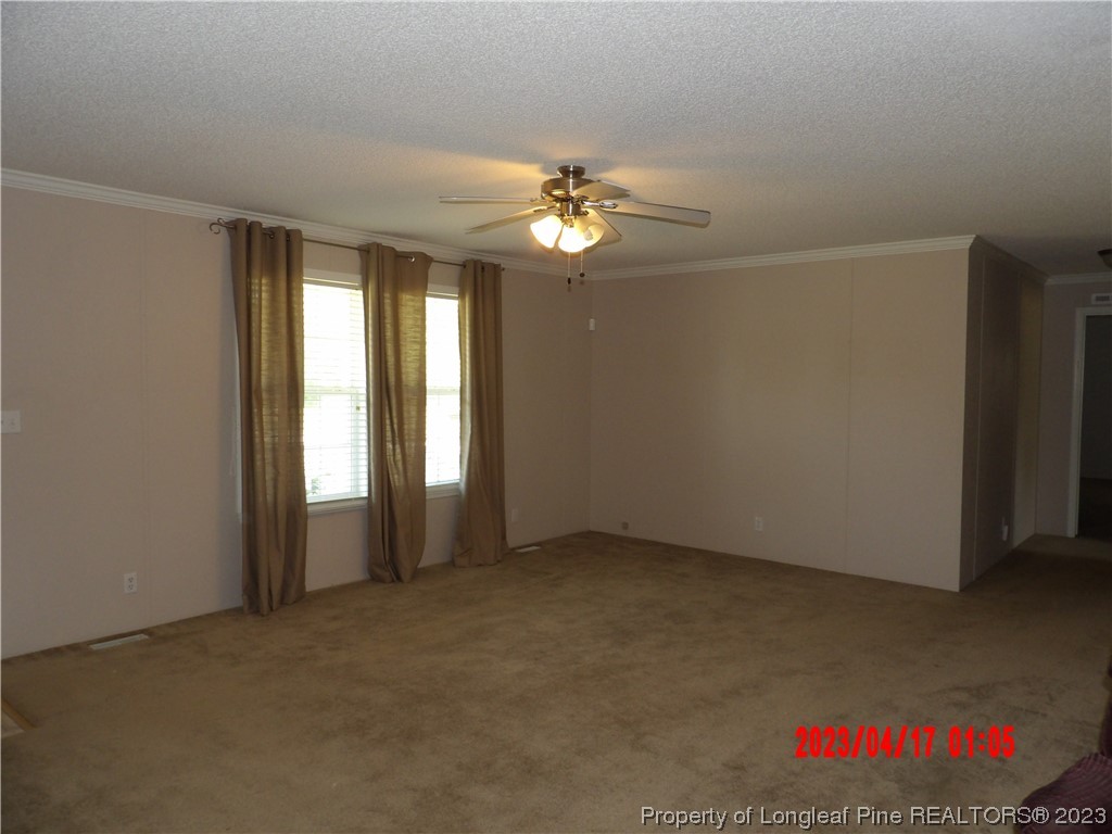 7349 Roslin Farm Road Hope Mills, NC 28348 - Photo 2 of 23 an empty room with windows and fan