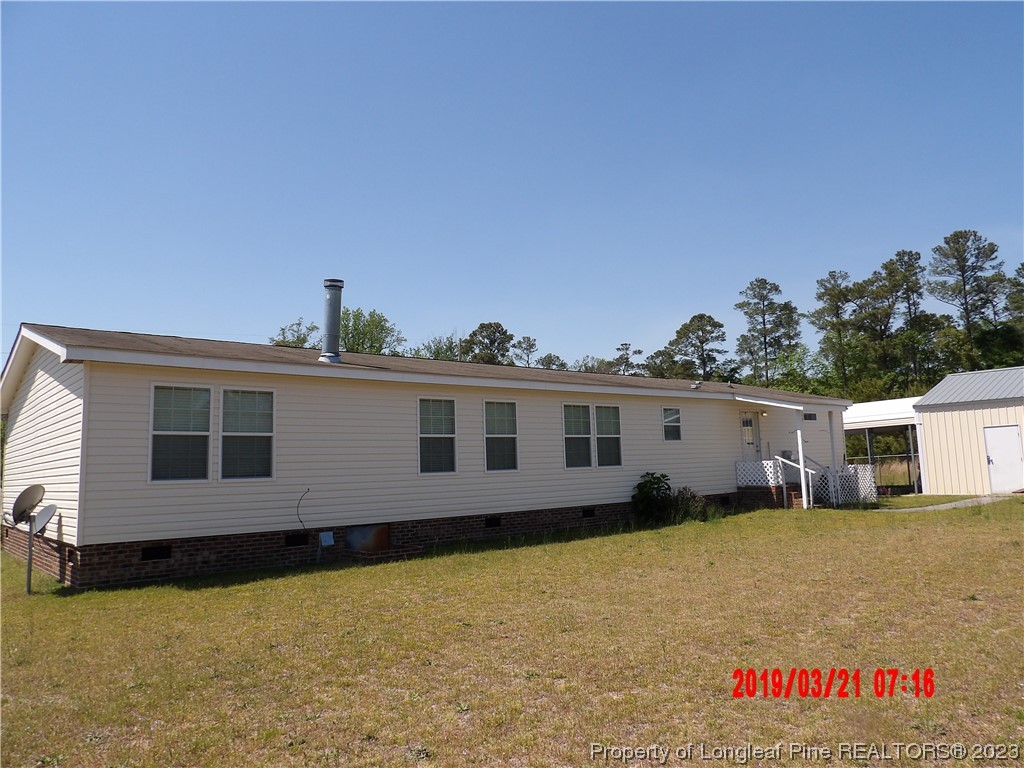 7349 Roslin Farm Road Hope Mills, NC 28348 - Photo 21 of 23 a front view of a house with a yard