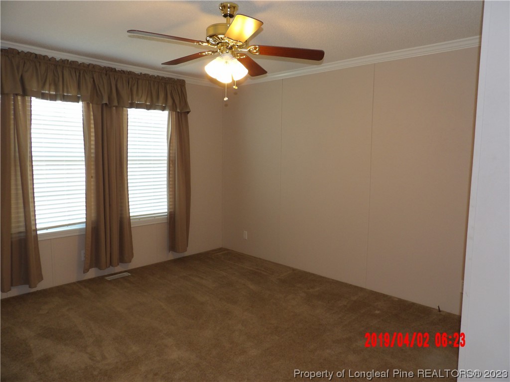 7349 Roslin Farm Road Hope Mills, NC 28348 - Photo 8 of 23 an empty room with windows and fan