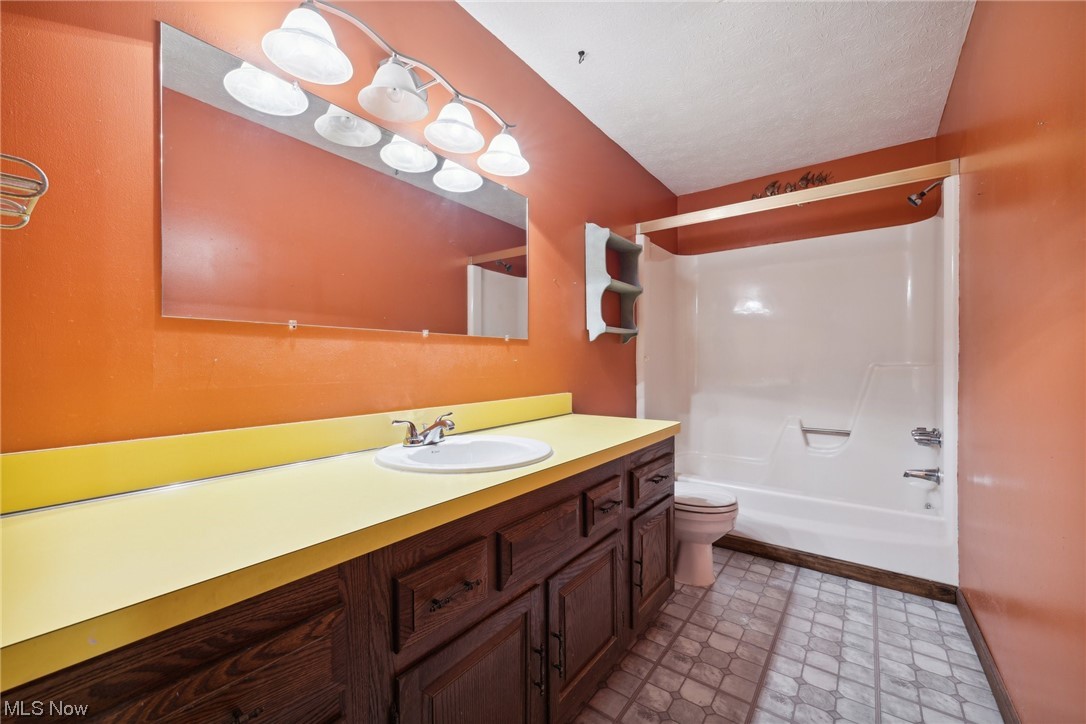 2715 Douglas Road Ashtabula, OH 44004 - Photo 28 of 34 Full bathroom with vanity, mirror, shower / bathing tub combination, and light tile flooring