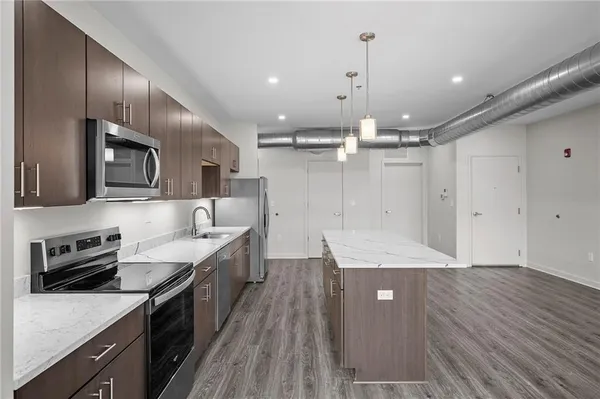 a kitchen with a sink appliances and cabinets