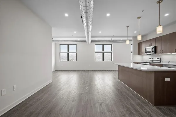 a view of kitchen with sink and wooden floor