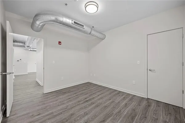 a view of a room with wooden floor