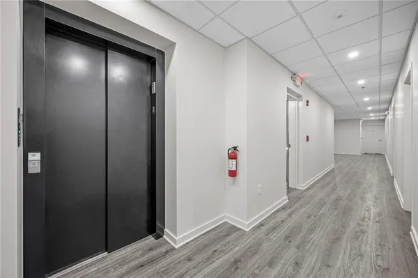 a view of hallway with wooden floor