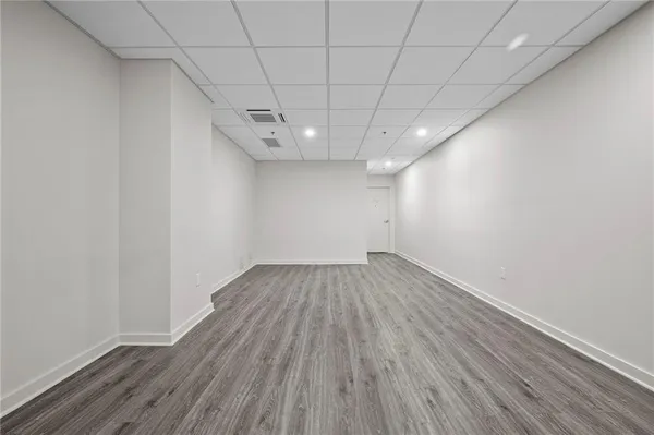a view of an empty room with wooden floor