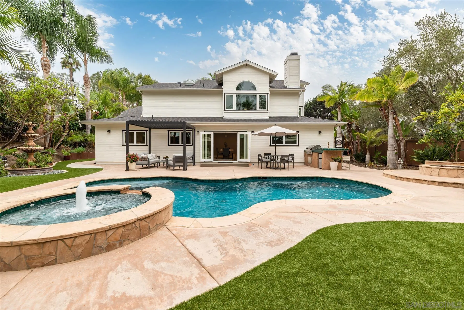 a front view of a house with patio yard and swimming pool