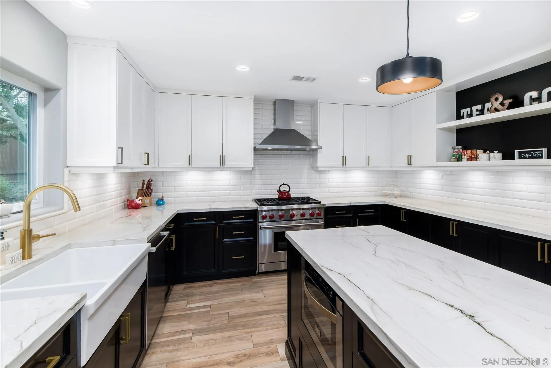 815 Marisa Lane Encinitas, CA 92024 - Photo 12 of 41 a kitchen with stainless steel appliances granite countertop a sink a stove and a wooden floors