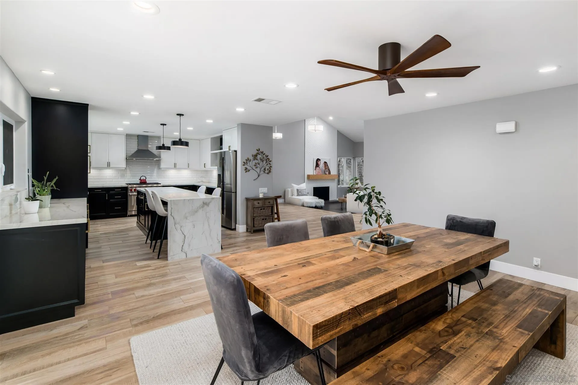 815 Marisa Lane Encinitas, CA 92024 - Photo 15 of 41 a dining hall with stainless steel appliances kitchen island granite countertop a dining table wooden floor and a view of kitchen