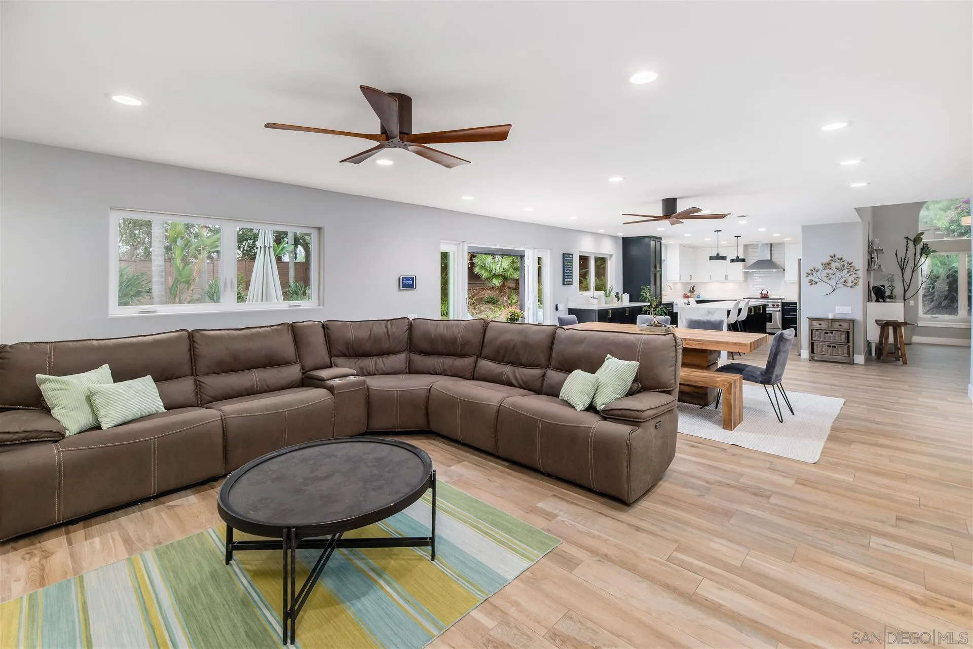 815 Marisa Lane Encinitas, CA 92024 - Photo 19 of 41 a living room with furniture a ceiling fan and a rug