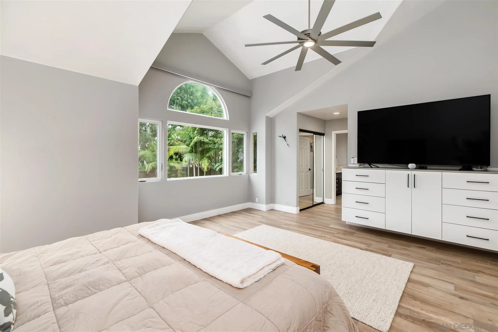 815 Marisa Lane Encinitas, CA 92024 - Photo 22 of 41 a bedroom with a bed a flat screen tv on dresser and a window