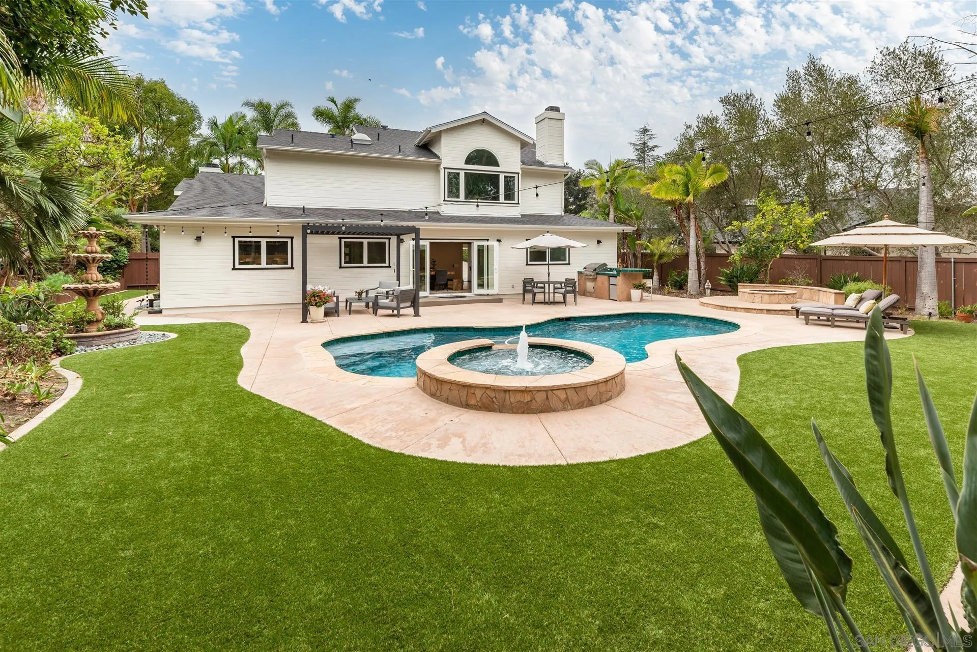 815 Marisa Lane Encinitas, CA 92024 - Photo 29 of 41 a view of a house with swimming pool and a garden