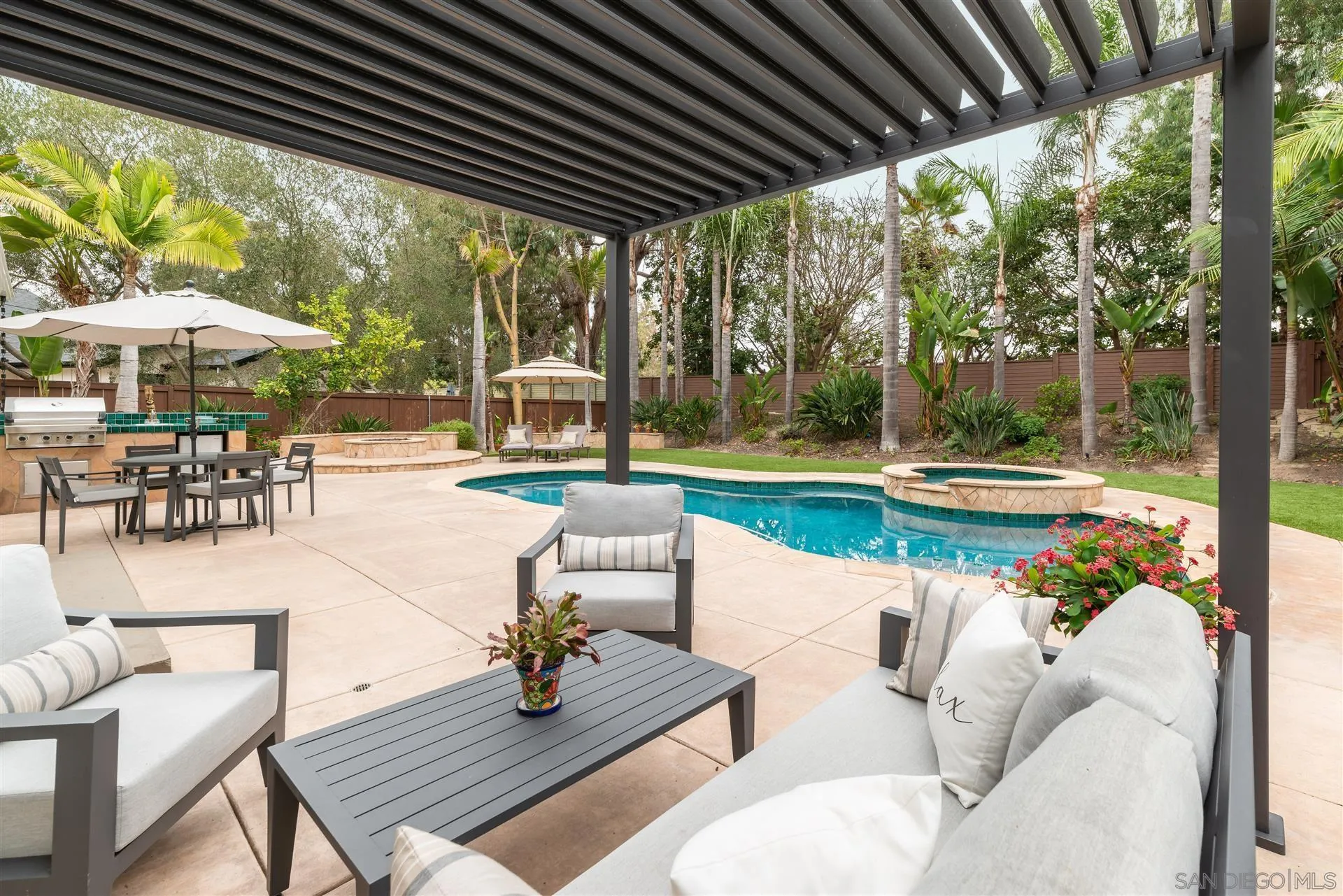 815 Marisa Lane Encinitas, CA 92024 - Photo 33 of 41 a view of a patio with a table chairs and a backyard