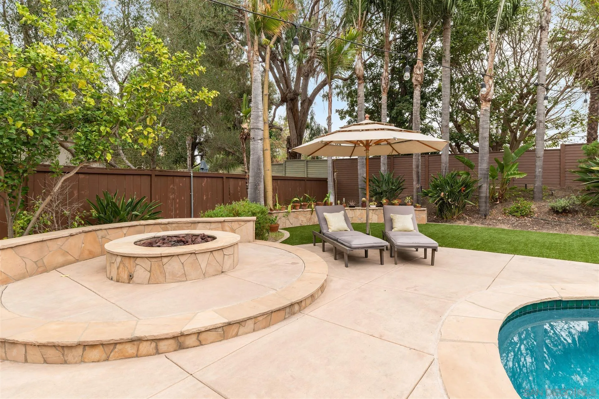 815 Marisa Lane Encinitas, CA 92024 - Photo 34 of 41 a view of a patio with a table and chairs under an umbrella