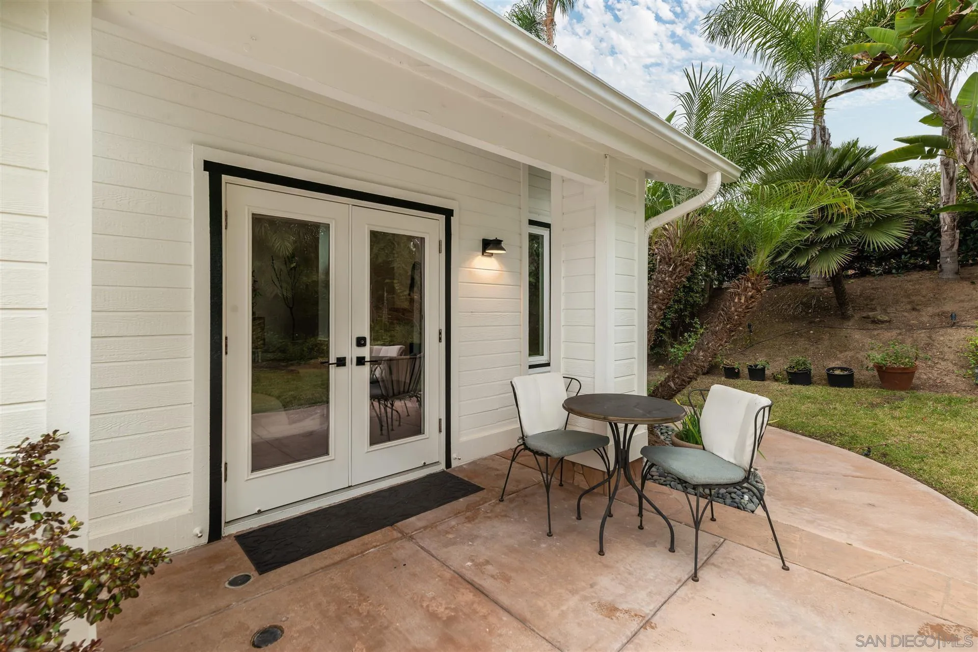 815 Marisa Lane Encinitas, CA 92024 - Photo 36 of 41 a view of a patio with a table and chairs and potted plants