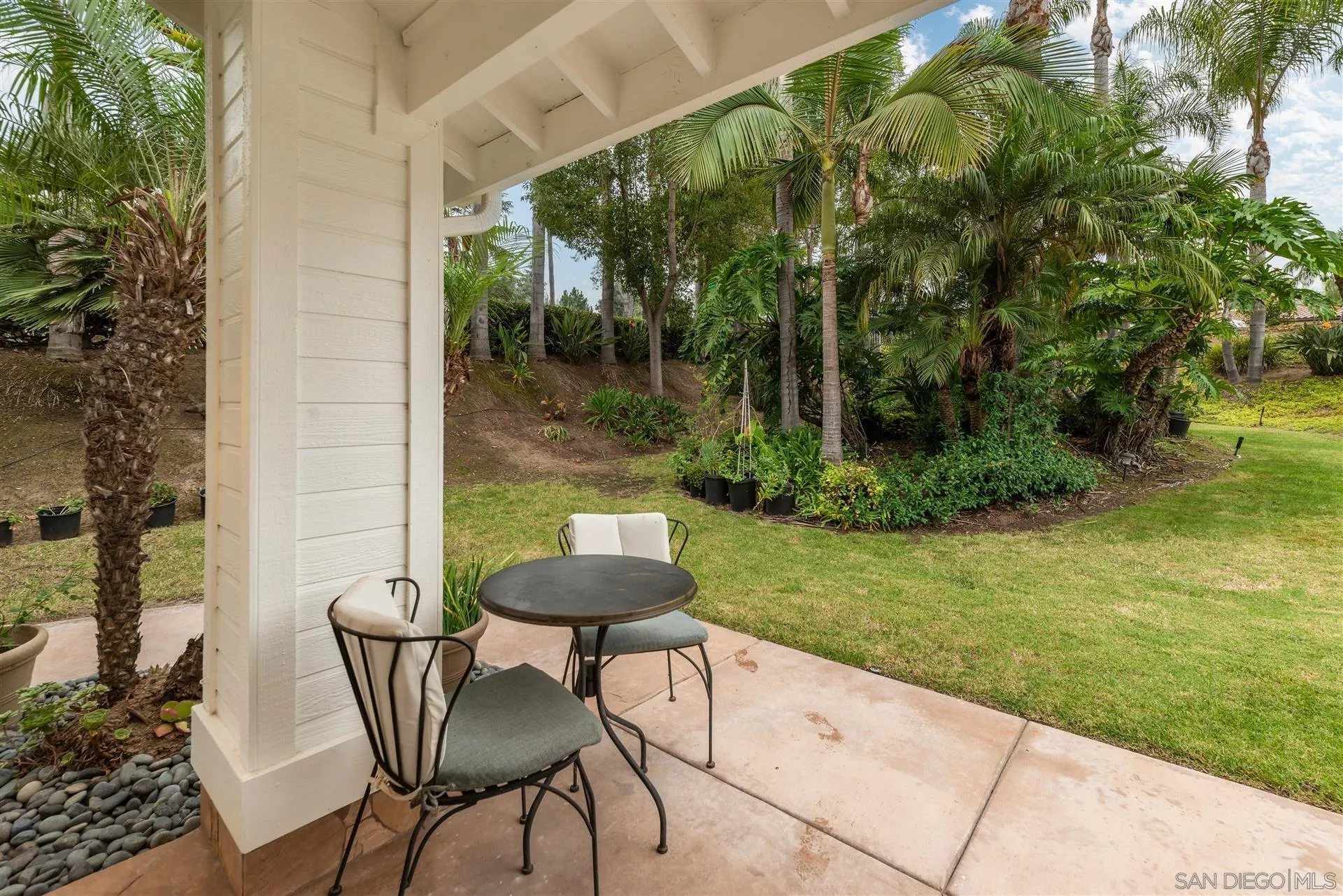 815 Marisa Lane Encinitas, CA 92024 - Photo 37 of 41 a view of a patio with a table chairs and a yard
