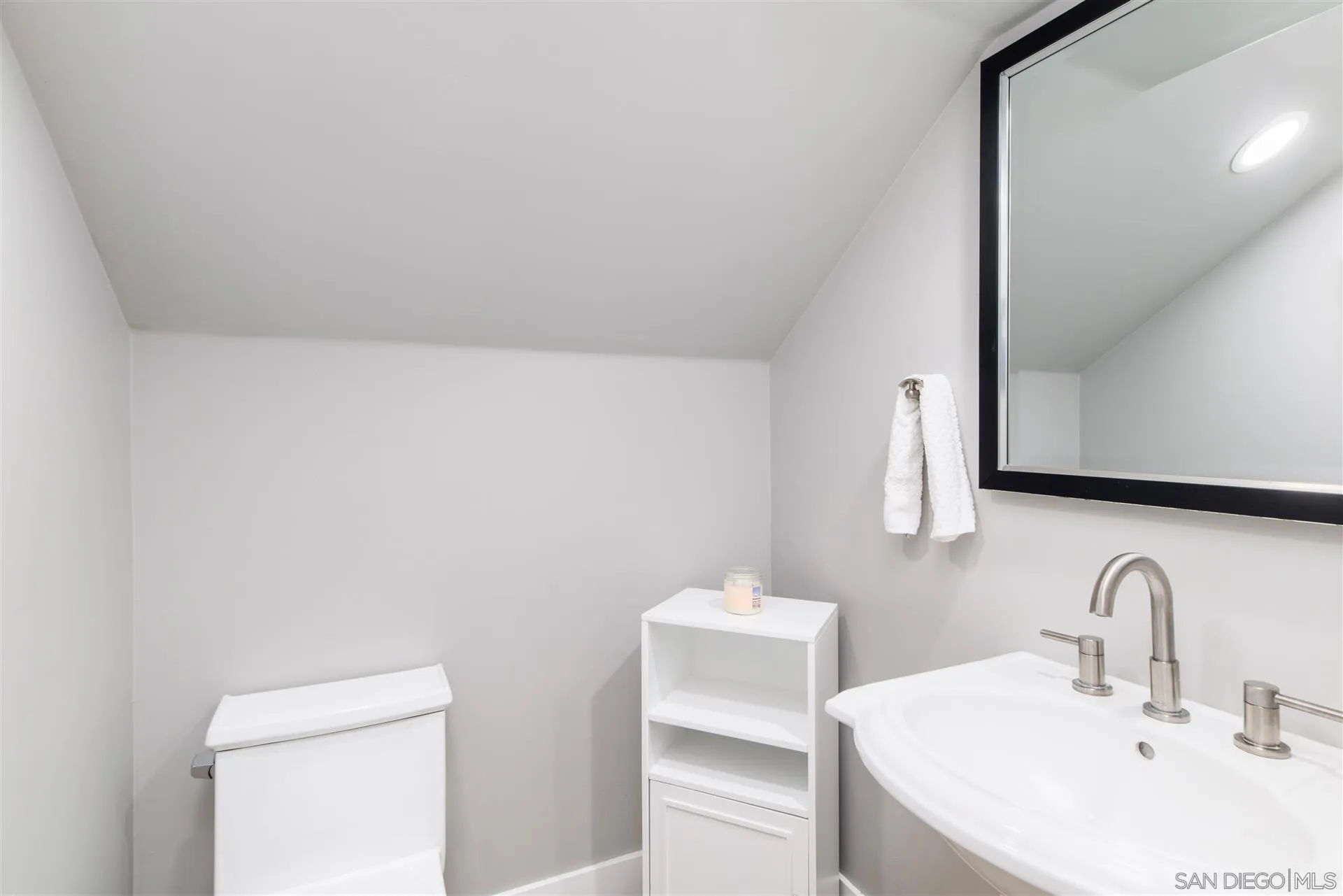 815 Marisa Lane Encinitas, CA 92024 - Photo 40 of 41 a bathroom with a sink and a mirror