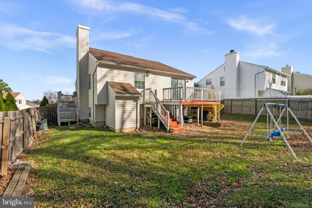 a view of a house with a big yard and a large tree