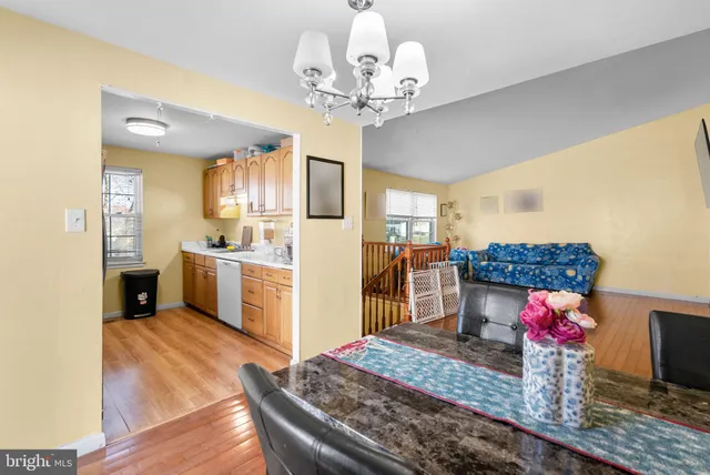 a kitchen that has a lot of white cabinets and stainless steel appliances