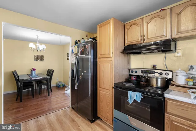 a kitchen with stainless steel appliances granite countertop a stove refrigerator and cabinets