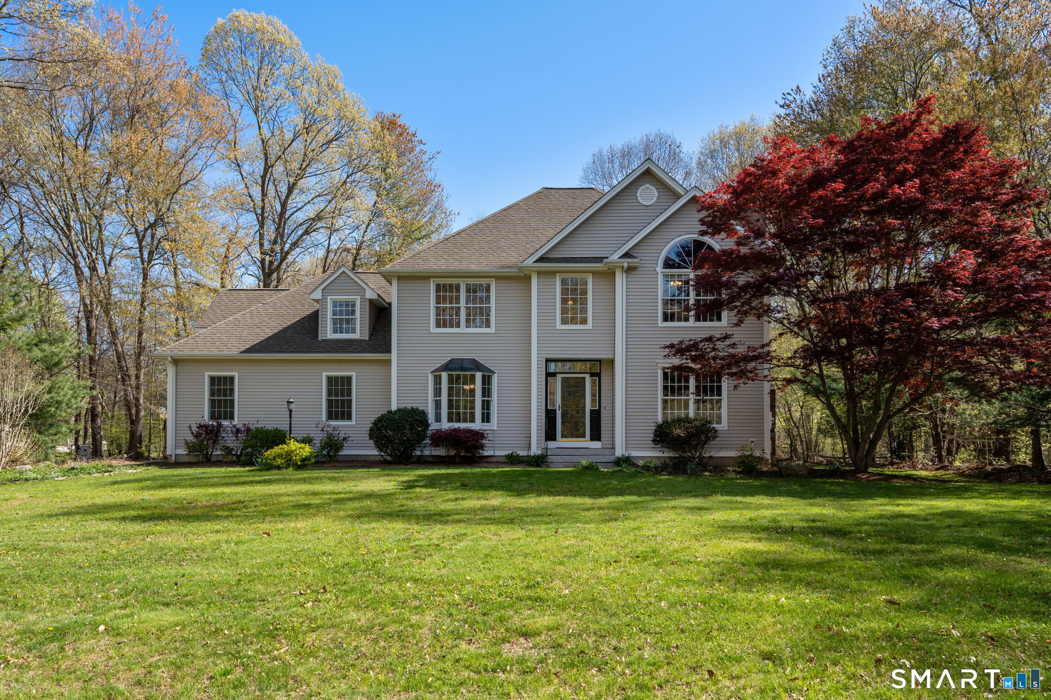 107 Country Lane Hebron, CT 06248 - Photo 1 of 37 a front view of house with yard and green space