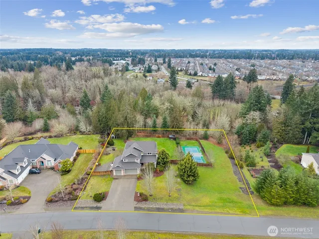 an aerial view of a house with a swimming pool