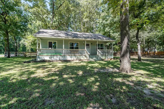 a front view of house with yard and green space