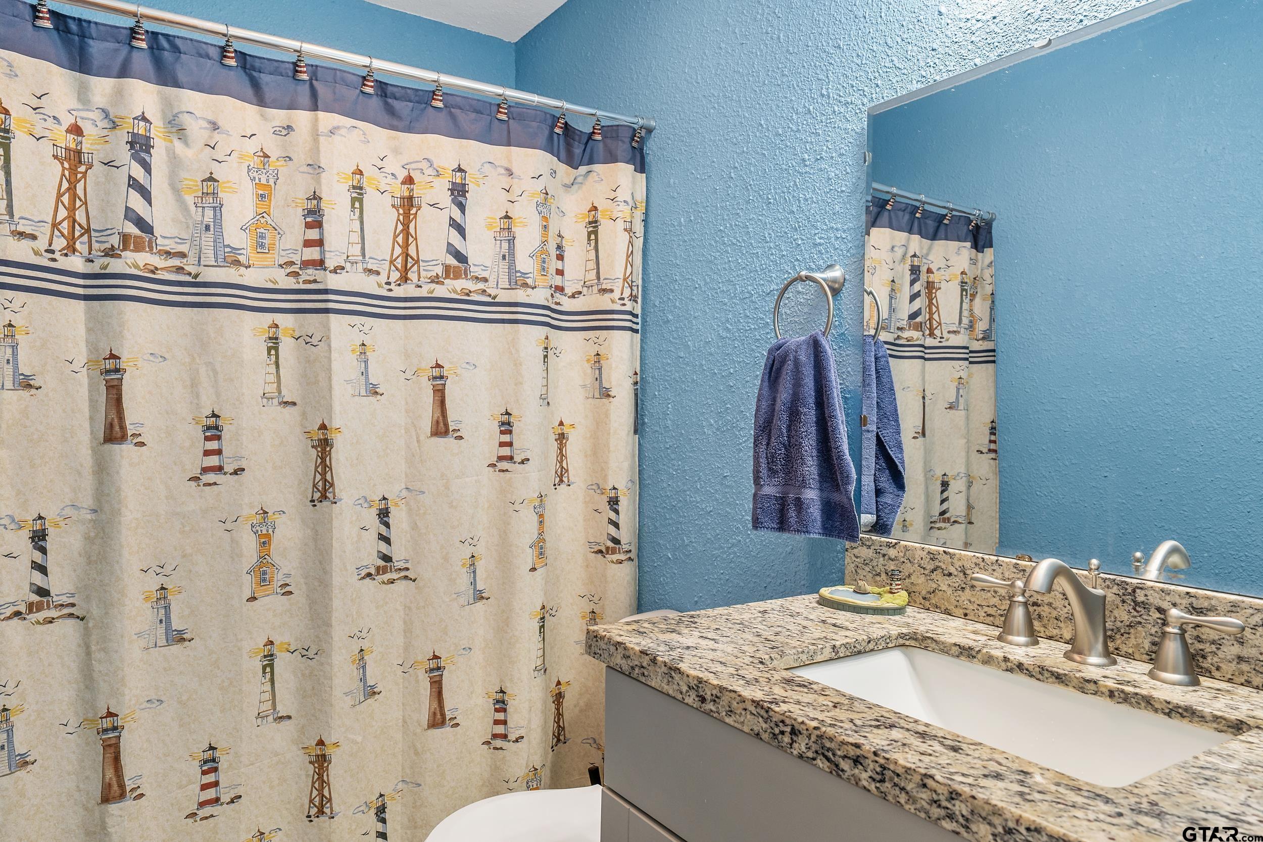 230 Deborah Street Bullard, TX 75757 - Photo 11 of 23 a bathroom with a granite countertop sink and a mirror