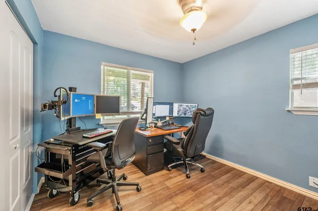 a view of a workspace with furniture and a window