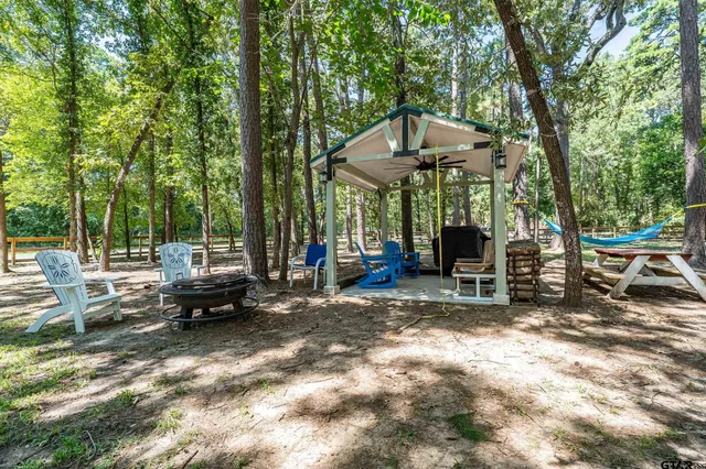 a backyard of a house with barbeque oven table and chairs