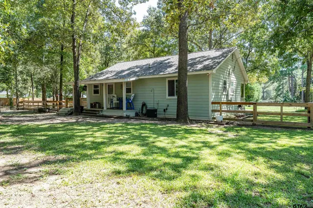 a backyard of a house with barbeque oven
