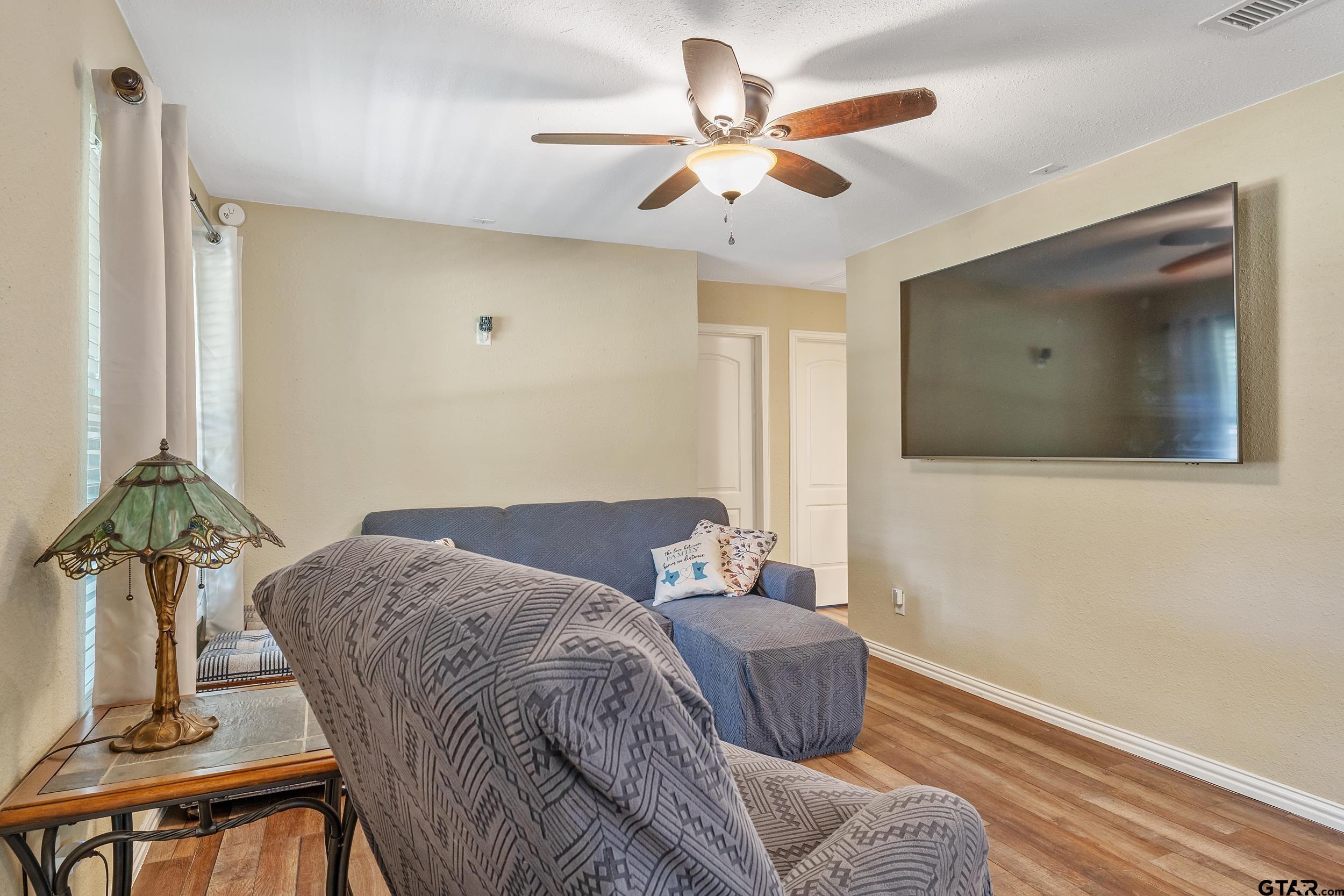 230 Deborah Street Bullard, TX 75757 - Photo 2 of 23 a bedroom with a bed and a chandelier