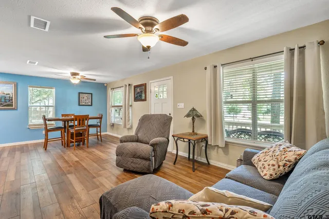 a living room with furniture and wooden floor
