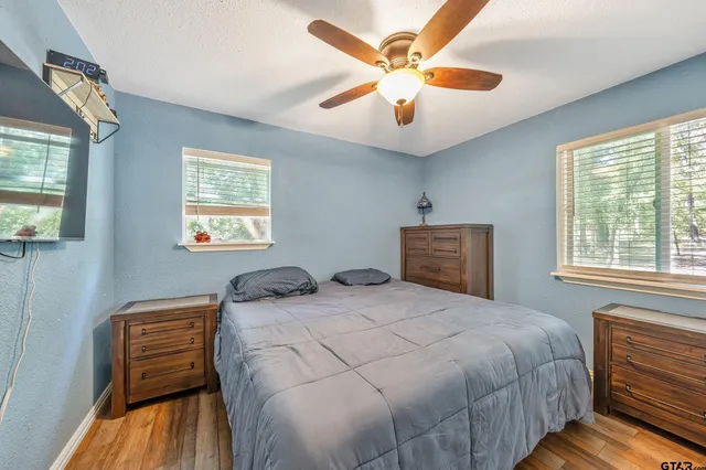 a bedroom with a bed and a chandelier