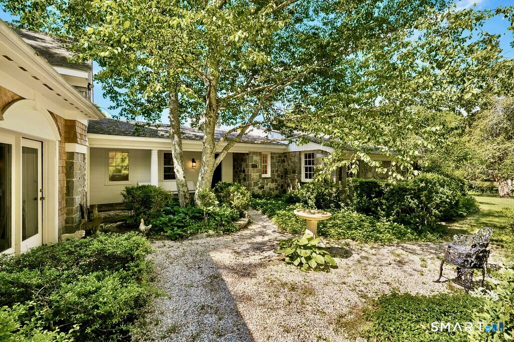 261-1 Grassy Hill Road Lyme, CT 06371 - Photo 40 of 40 The courtyard serves as a beautiful extension of the home, opening to the original front entrance and covered porch while providing direct access to the striking main-level library and studio.